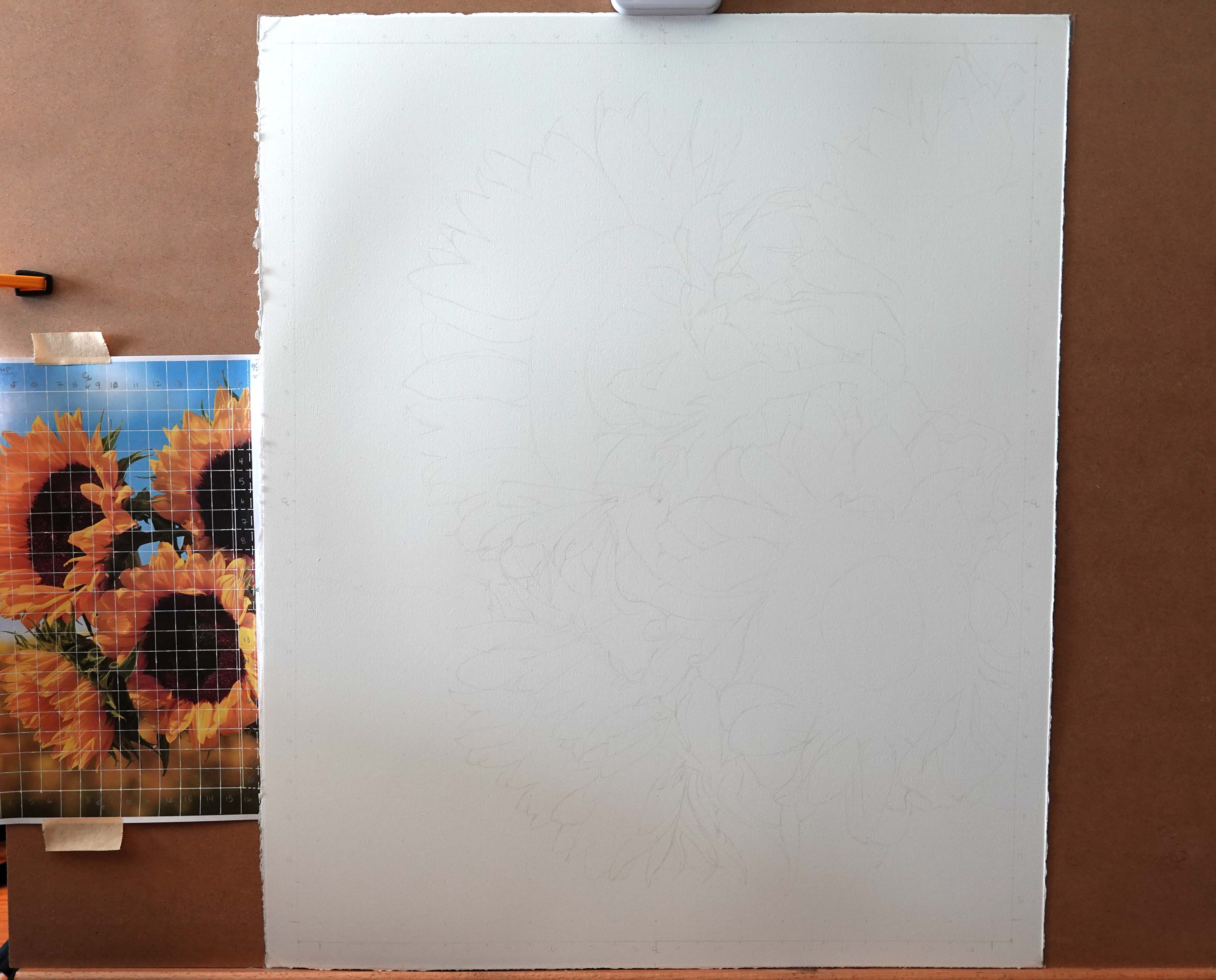 A picture of an easel with paper and reference photo